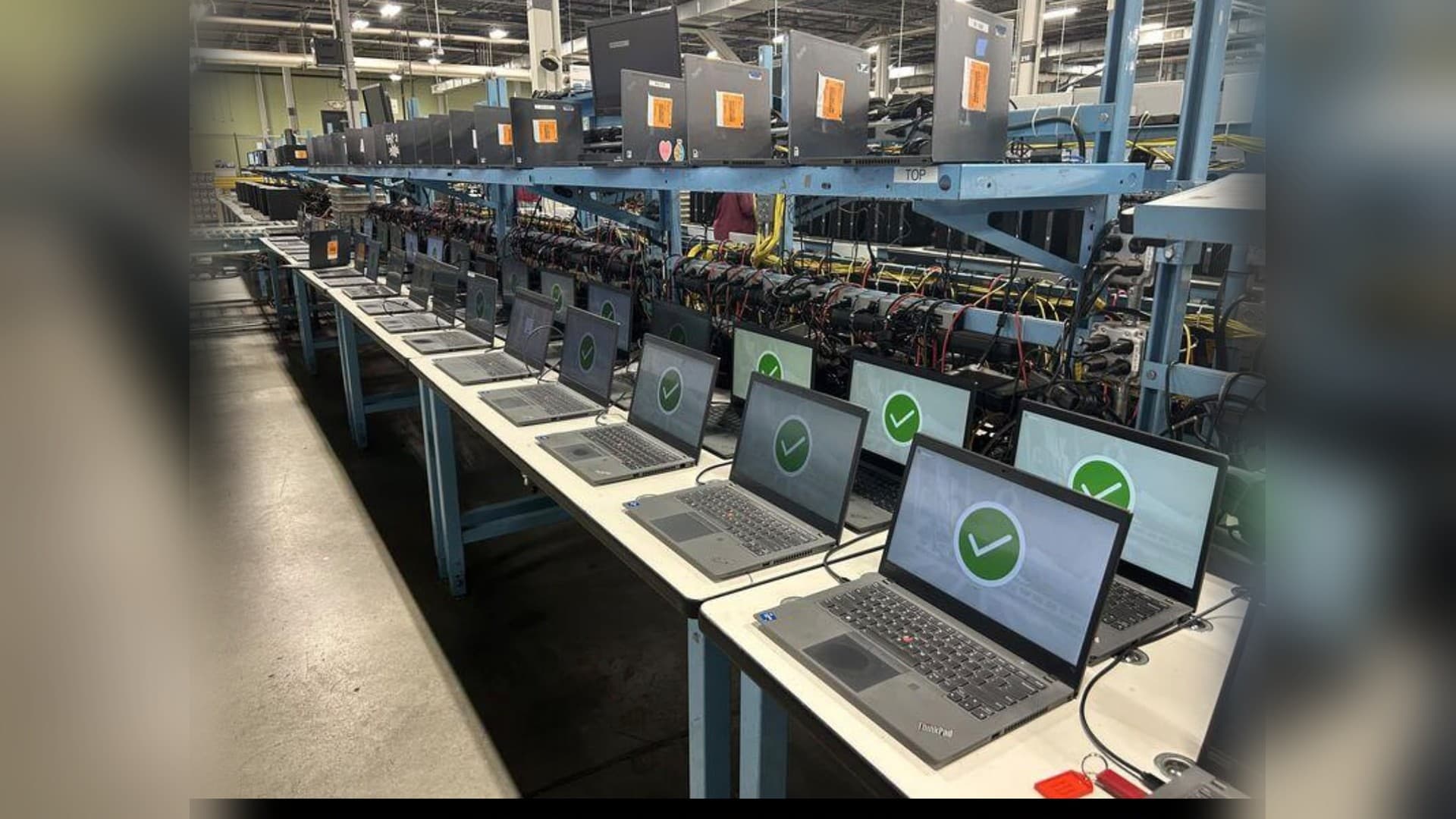 Bancada da Brain com dezenas de notebooks alinhados e testados, prontos para sair para os clientes